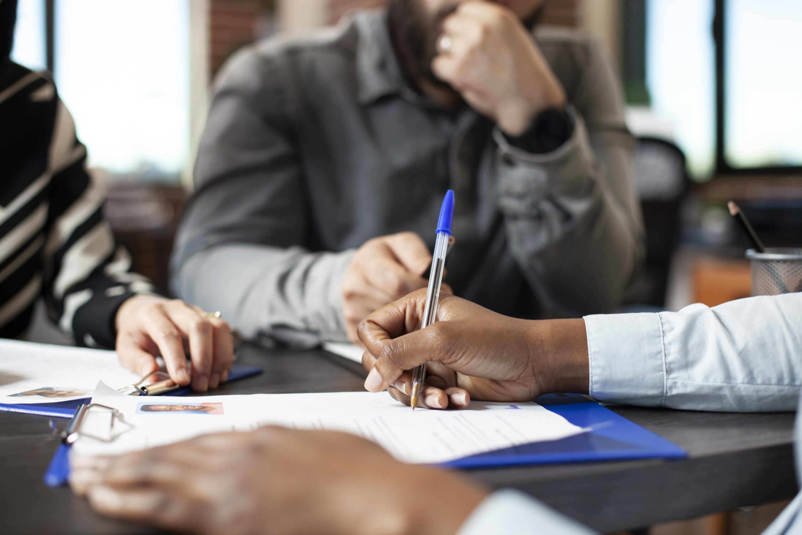 black person signing job offer paperwork scaled